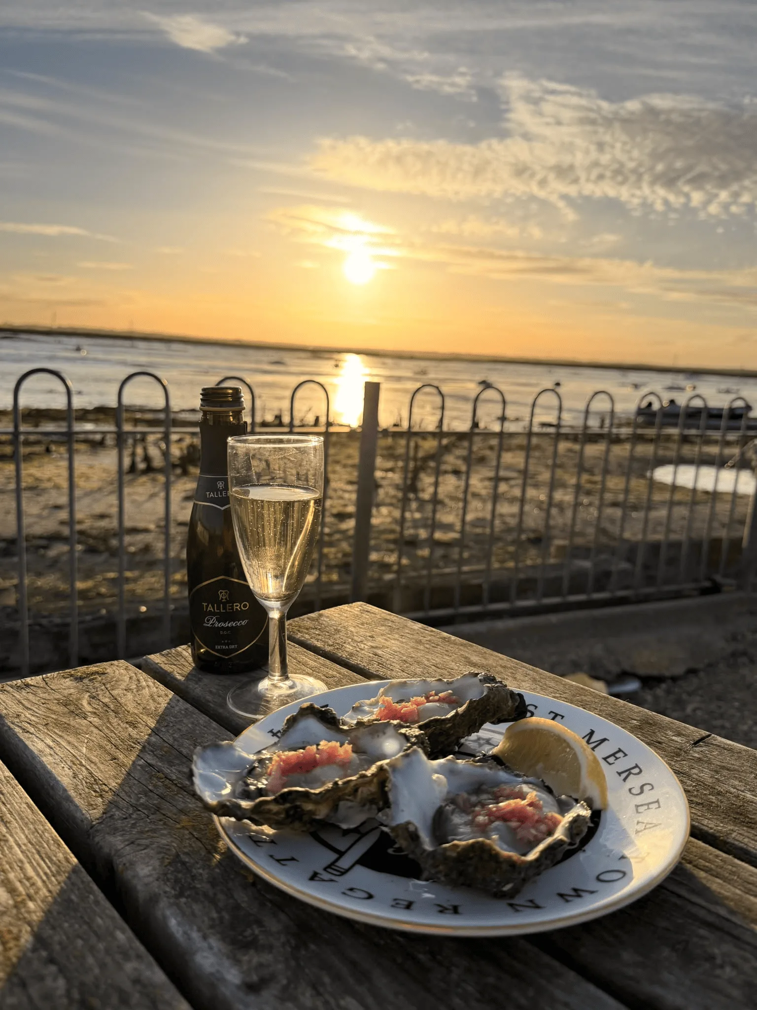 Mersea oysters with shallot vinaigrette and lemon beside the Blackwater at sunset