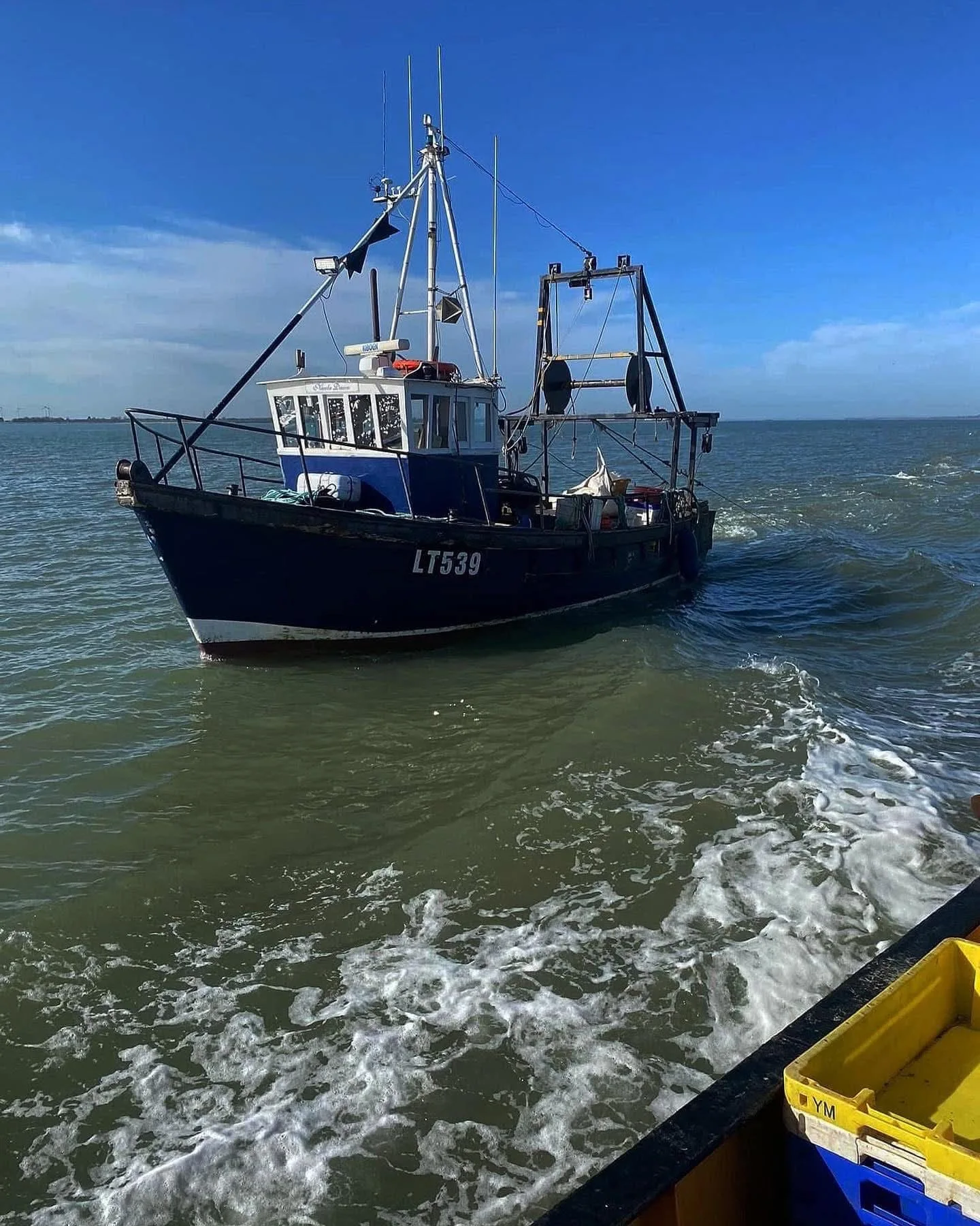 A working fishing boat crossing the water near West Mersea